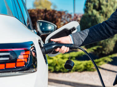 A person charging their EV vehicle